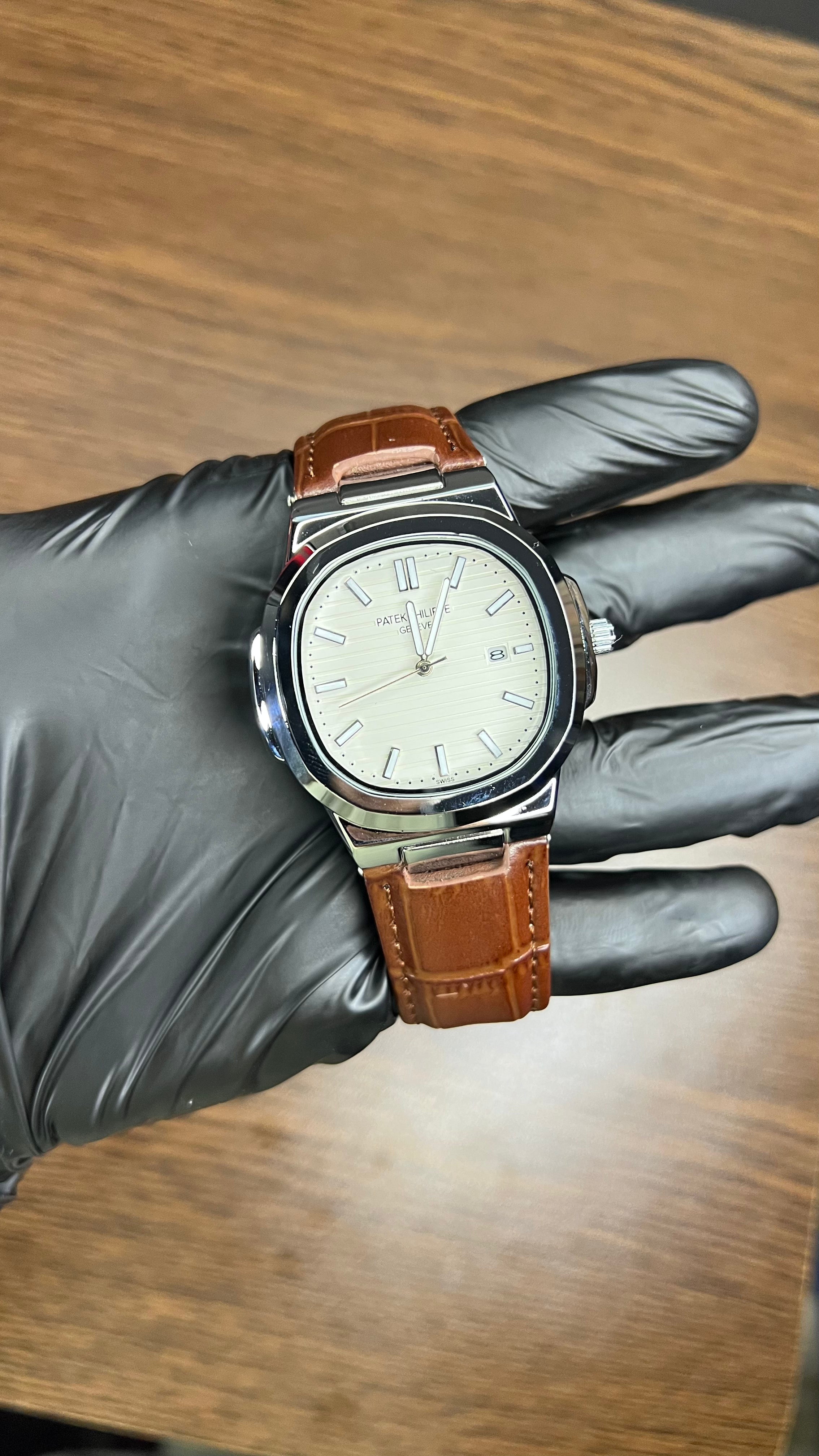 Patek Philippe Nautilus Stainless Steel & Black Leather Strap – Black Dial with Date Display