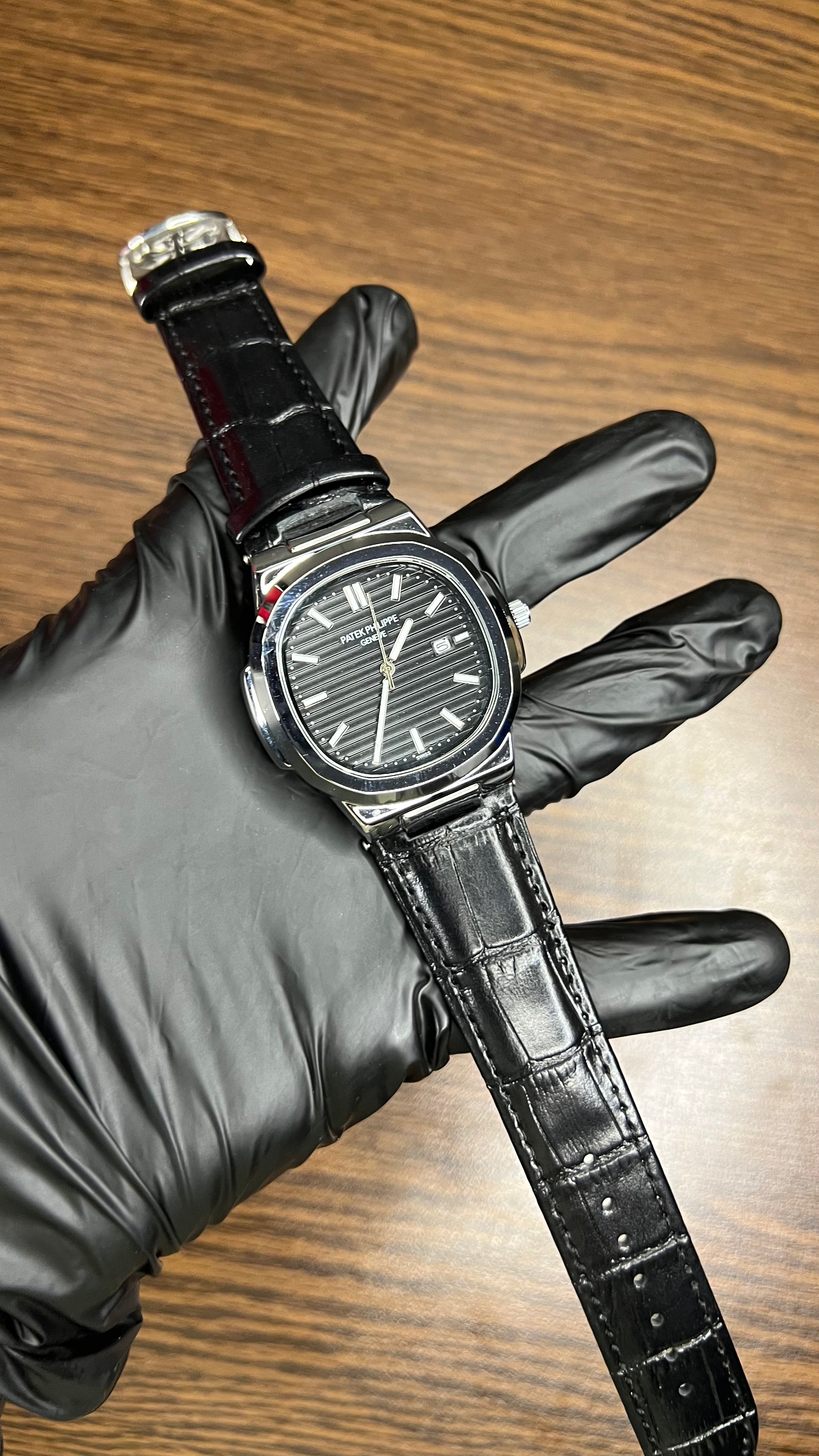 Patek Philippe Nautilus Stainless Steel & Black Leather Strap – Black Dial with Date Display