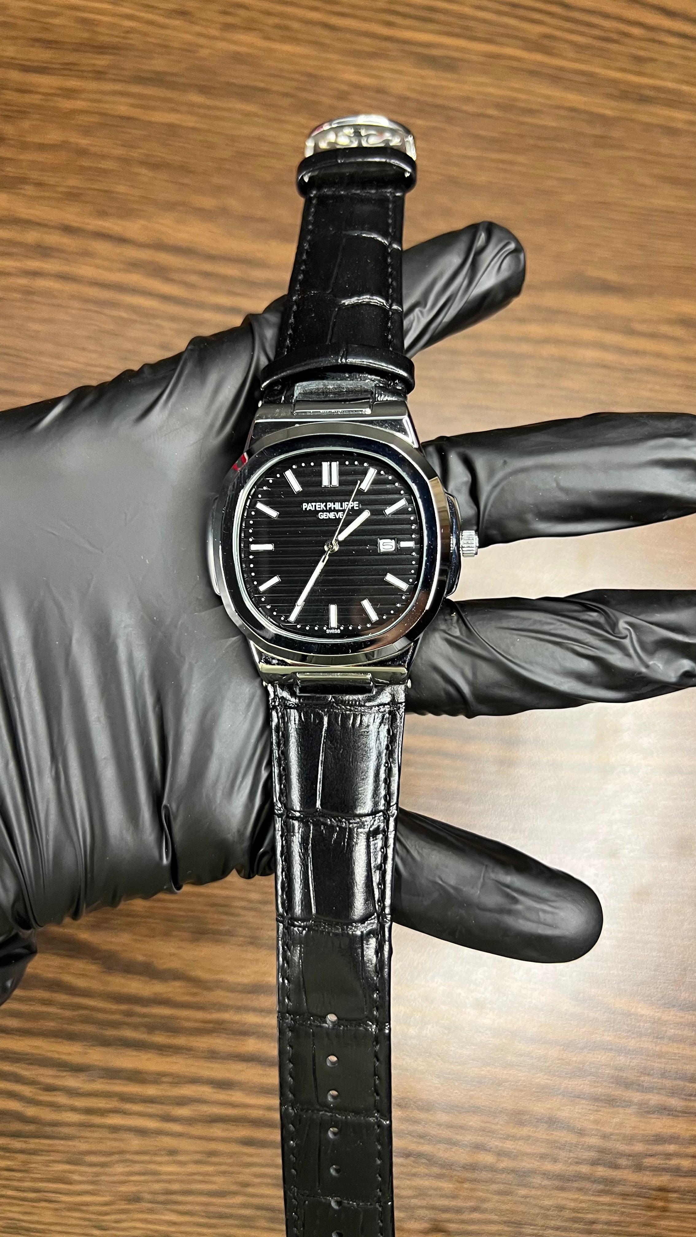 Patek Philippe Nautilus Stainless Steel & Black Leather Strap – Black Dial with Date Display
