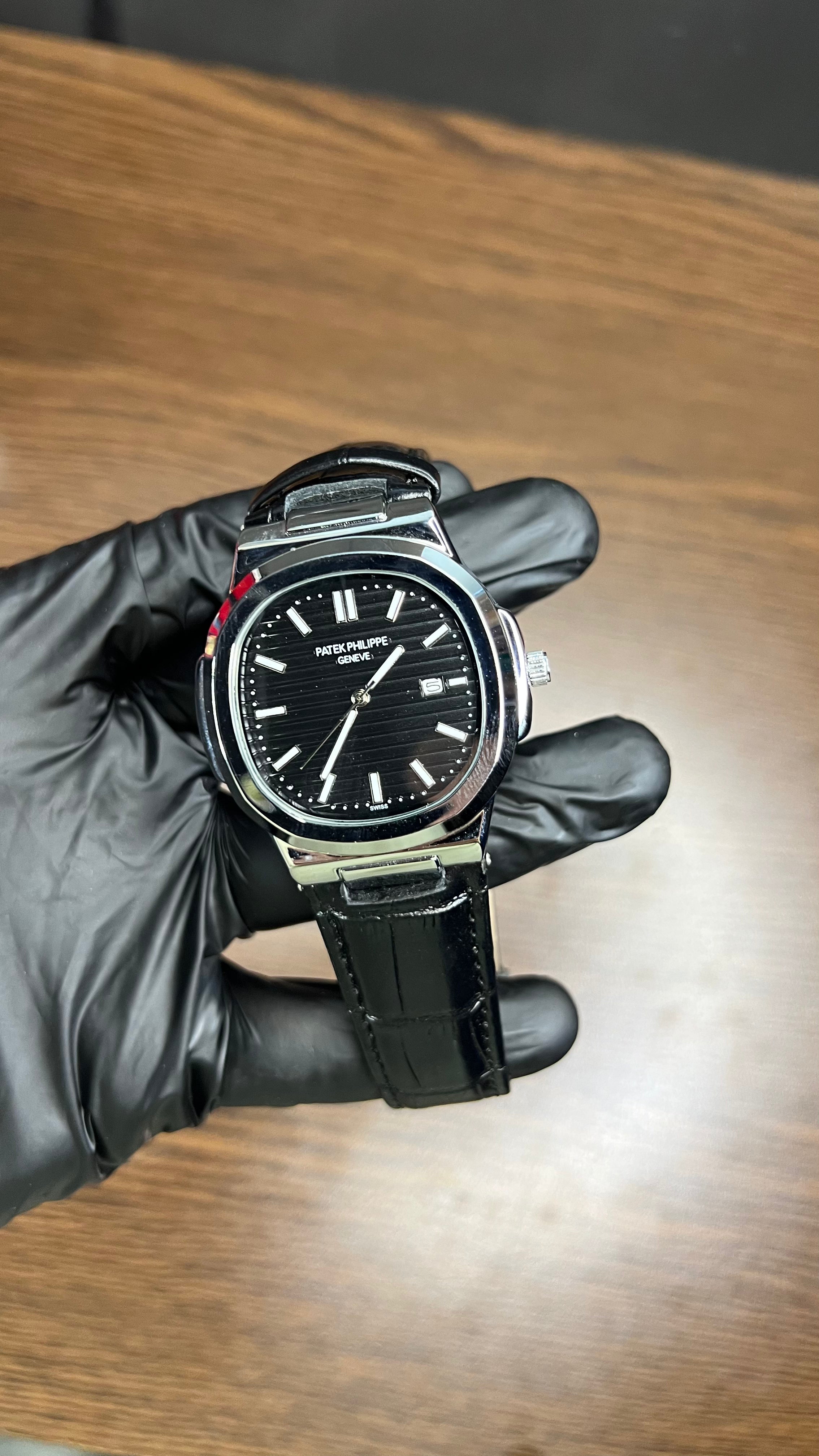 Patek Philippe Nautilus Stainless Steel & Black Leather Strap – Black Dial with Date Display