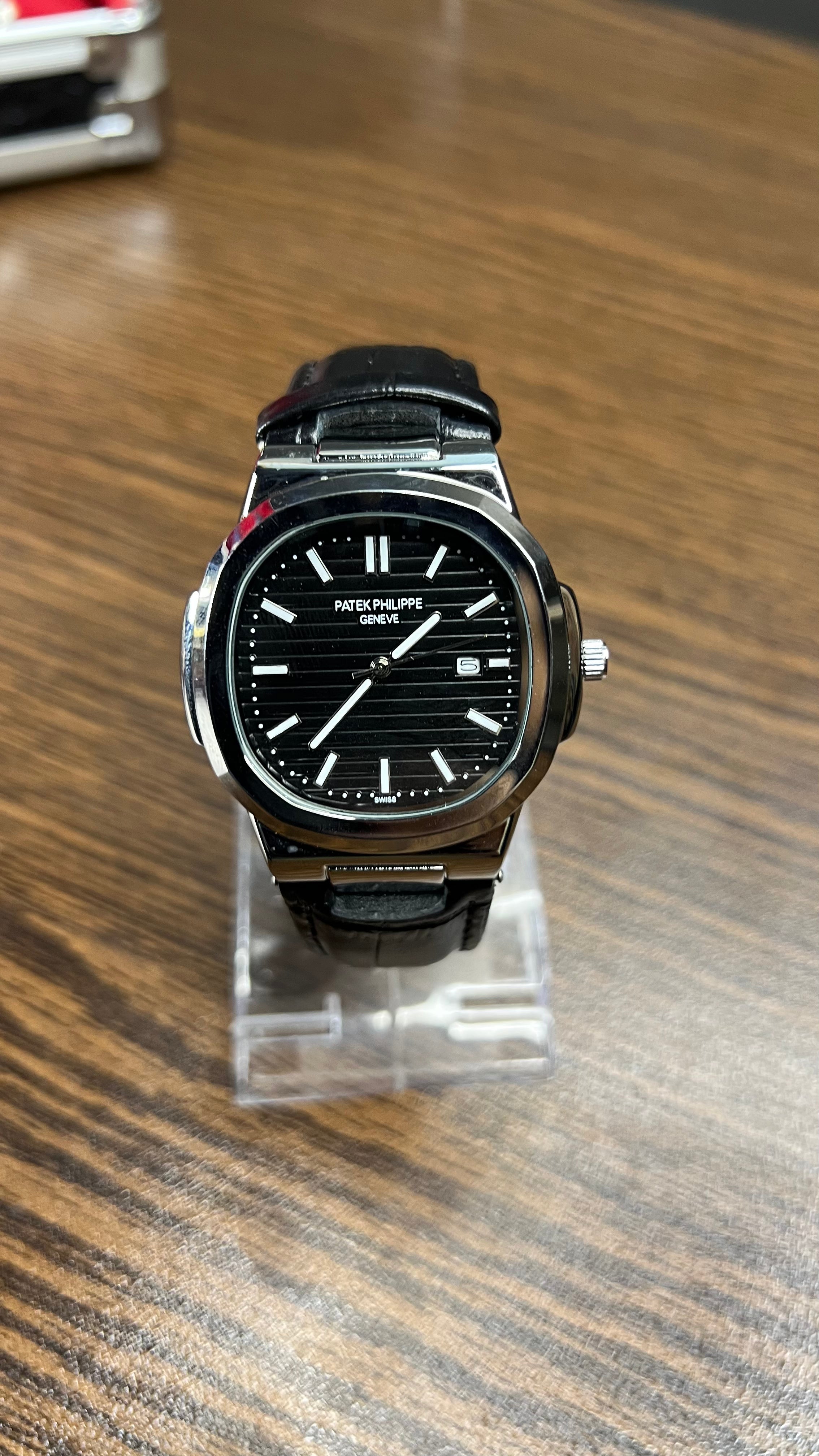 Patek Philippe Nautilus Stainless Steel & Black Leather Strap – Black Dial with Date Display